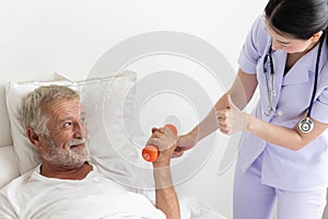 Senior retirement man doing dumbbell fitness training with physiotherapist and thumb up