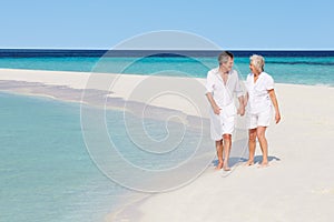 Senior Romantic Couple Walking On Beautiful Tropical Beach