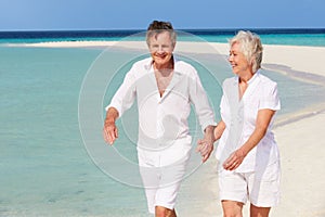 Senior Romantic Couple Walking On Beautiful Tropical Beach