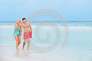 Senior Romantic Couple Walking In Beautiful Tropical Sea