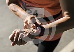 Senior runner using a fitness tracker