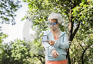 Senior runner using a fitness tracker