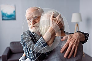 Senior, sad man hugging wife, sick