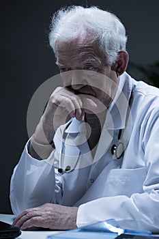 Senior sad physician