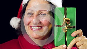 Senior Santa Claus Lady Showing Wrapped Green Gift