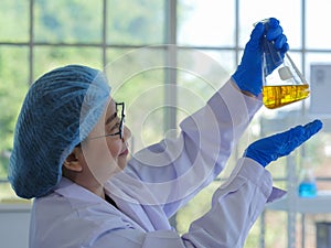 A senior scientist carrying out a flask