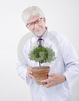 Senior scientist holding plant