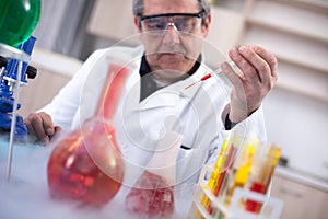 senior scientist with protective glasess researching in laboratory