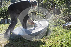 Senior sculptor polishing and shaping stone piece