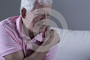 Senior with shoulder pain photo