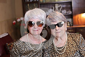Senior sisters with matching leopard outfits