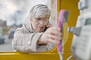 Senior with Smartphone and Handset