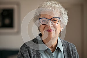 Senior smiling woman with spectacles looking at camera