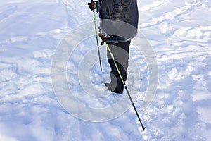 Senior at the snow in winter nordic walking