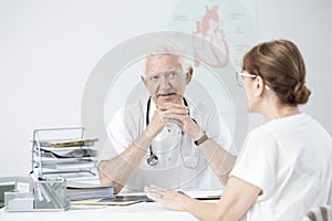 Senior specialist listening to patient