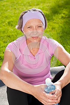 Senior sportive woman happy hold bottle water