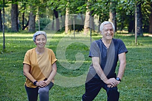 Senior spouses doing sportive exercises outdoor