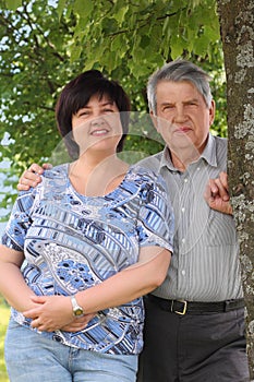 Senior standing and embracing his daughter