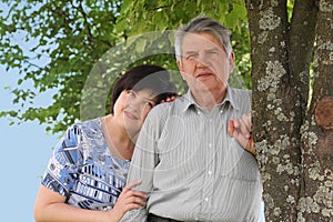 Senior standing, his daughter embracing him