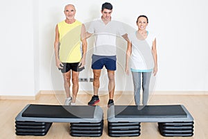 Senior step exercise with personal trainer