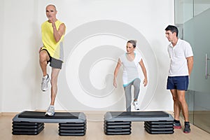 Senior step exercise with personal trainer