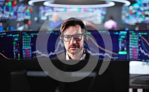 Senior Stock Trader Man Using Multiple Computer Monitors