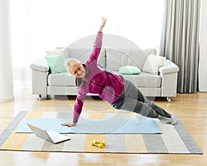 senior stretching exercise woman training lifestyle sport fitness home healthy gym exercising fit laptop yoga meditation