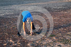 Senior stretching in the park