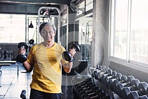 Senior strong man dumbbell exercise in gym