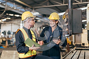 senior supervisor male talking with young new engineer employee training teaching for machine operate