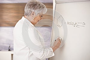 Senior teacher drawing on whiteboard