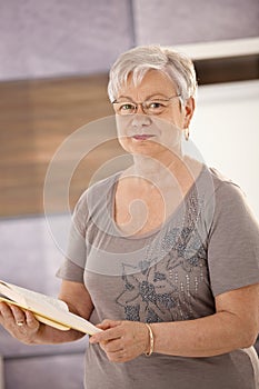 Senior teacher holding textbook