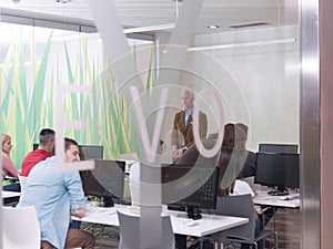 Senior teacher and students group in computer lab classroom