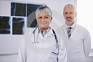 Senior team of doctors in portrait, smile in radiology with woman in leadership and man in hospital. Surgeon, healthcare