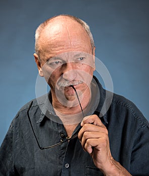 Senior thoughtful man with glasses