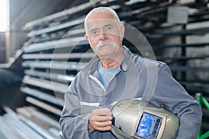 Senior tinsmith in workshop