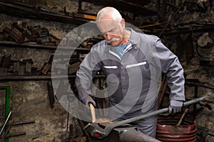 Senior tinsmith in workshop