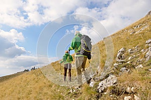 Senior tourist couple hiking at the beautiful mountains