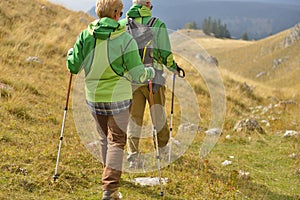 Senior tourist couple hiking at the beautiful mountains