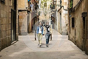 Senior tourist couple walking around Barcelona city enjoying summer vacation