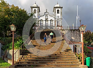 Senior tourists climbing stairs to church