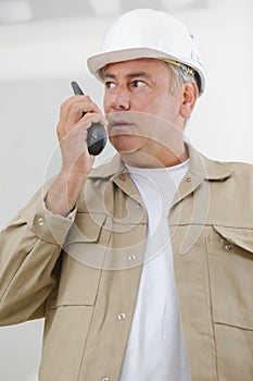 senior tradesman using walkie talkie