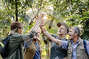 Senior trekkers giving a high five