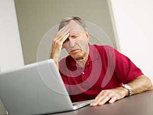 Senior using laptop computer