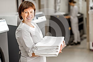 Senior washwoman in the laundry