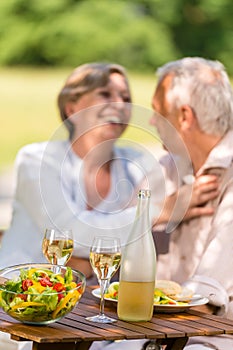 Senior wife and husband dining outdoors