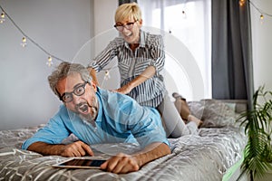 Senior wife supporting husband feel sudden back pain muscles tension injury at home