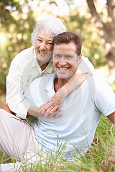 Senior Woman With Adult Son In Garden