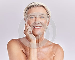 Senior woman applying beauty sunscreen, face cream or moisturizing lotion on skin isolated on studio background