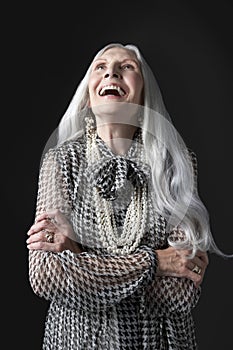 Senior Woman with Arms Folded Laughing